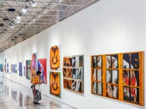woman looking at art printed on acrylic frame