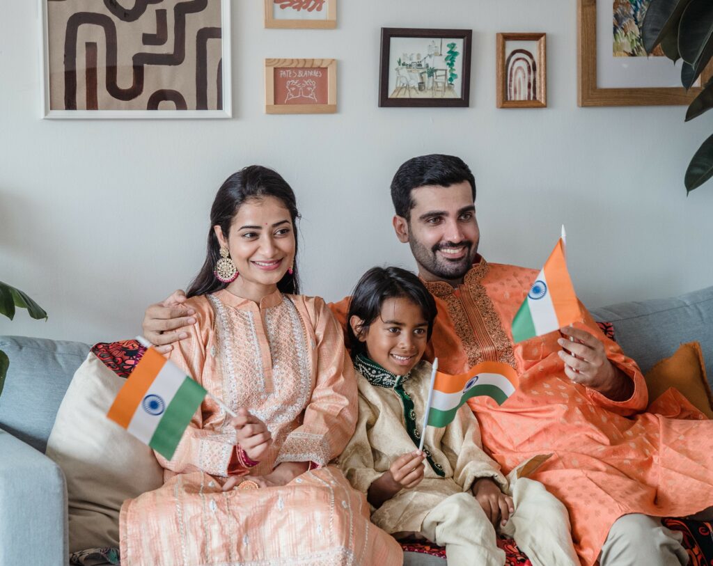 A family holding Indian Flags on Independence day.